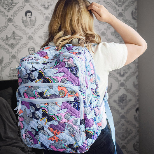 Model wearing a blue patterned Vera Bradley backpack 